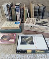 All 22 books standing and stacked, showing a mix of authors and formats