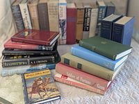 Overview of three stacks showing variety of hardcovers and anthologies