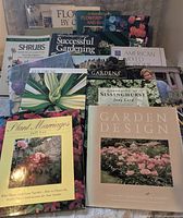 Front view showing 12 of the 16 oversized gardening books with titles and covers