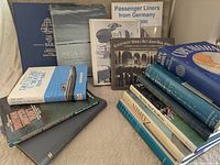 Group view of all books displayed upright and stacked, showing covers and spines