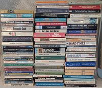 Overall view of three tall stacks showing majority of the 75 books