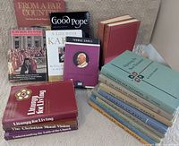 Group shot showing majority of books standing and stacked, front covers visible