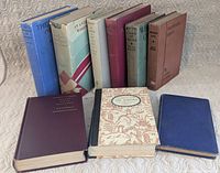 Front view showing all nine vintage books upright