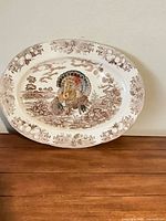 Full view of ceramic platter showing turkey motif and floral border