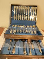 Open chest showing full set of flatware in slots and drawer