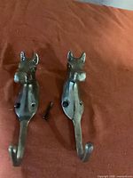 Front view showing both horse head wall hooks with screws