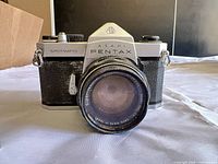 Front view of camera showing model name and attached lens