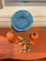 Overall lot view showing basket, gecko and pumpkin votives