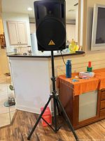 Speaker on tripod stand, full view of lot