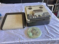Recorder, lid, and wrapped tape reel displayed