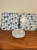 Two square trays and stacked round plates displayed