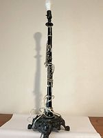 Full view of clarinet lamp standing on metal base