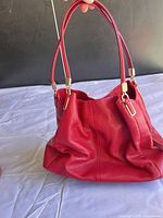 Front view of red Coach leather hobo bag