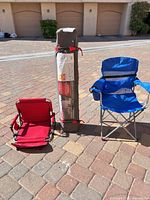 All items in lot: folded bag, unfolded red Coleman chair, adjacent items for scale