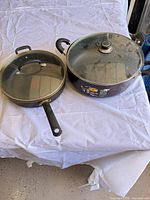 Frying pan and sauce pot side by side with lids on