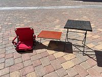 All three items—wicker side table, laminate low table, red chair—shown folded/unfolded on patio