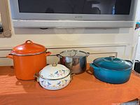 All four pots side by side showing size, color and included lids