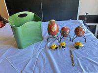 All items group shot: holder, eggs on stands, ladybugs, watch