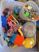 Overview of tote contents: dolls, Hulk, Transformers, accessories