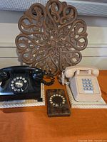 Group shot of both phones, novelty block and carved plaque