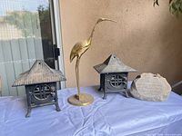 Full lot view showing two lanterns, heron statue, plaque