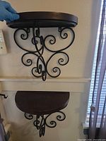 Front view of upper shelf showing wood top and full metal scroll bracket