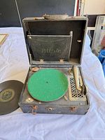Open PAL Jr. phonograph showing green felt platter, tonearm and case