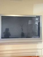 Front view of Panasonic silver flat panel TV on wall mount