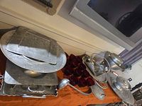 Overview of hammered pewter pieces, trays, ladle and 12 red glass cups