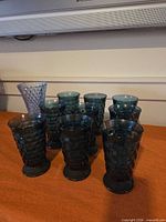 Group of textured blue and teal glasses on table