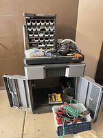 Overall view of cabinet, parts organizer, power tool, straps crate