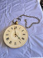 Front view showing clock face, loop and chain