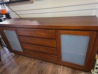 Front view showing overall design with drawers and frosted glass doors