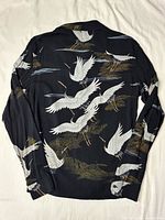 Back view of black shirt with crane print