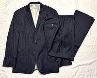 Full view of jacket and trousers laid flat