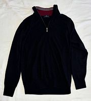 Full front view of black quarter-zip sweater laid flat