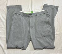 Front view of grey Hugo Boss pants laid flat