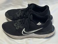 Left and right shoes, lateral view showing uppers, midsoles, laces