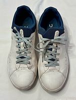 Top view of both sneakers showing uppers, laces, interior size marking