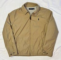 Full view of khaki Harrington jacket front zipped