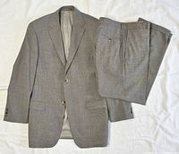 Suit jacket and trousers laid flat showing full set