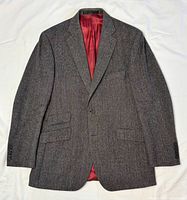 Full front view of blazer laid flat showing overall style, pockets, lapel, and lining