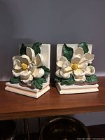 front view of both magnolia flower bookends on shelf