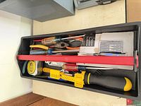 Tray with screwdrivers, pliers, tape measure, ratchet, bits