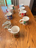All nine mugs arranged on table showing overall lot