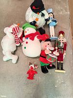 Group shot of all seven Christmas plush toys and wooden figurines