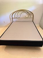 Overall view of queen metal bed frame with gold headboard assembled