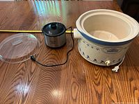 Slow cooker insert, plastic lid, Little Dipper warmer displayed on table