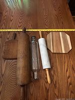 group shot of all five items on wood surface with tape measure for scale