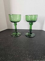 Front view of both green hand-blown goblets